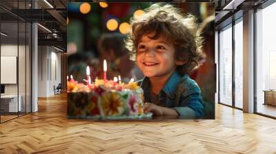 Little boy blowing out candles on his birthday cake. Wall mural