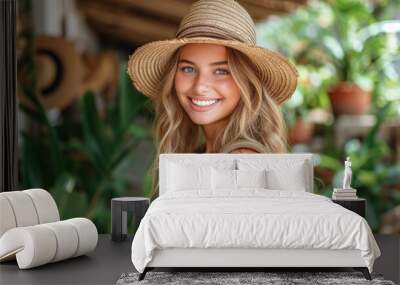 Radiant young woman with straw hat smiling in greenhouse Wall mural