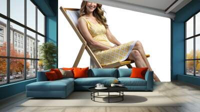 Smiling woman relaxing on a deck chair in a yellow dress Wall mural