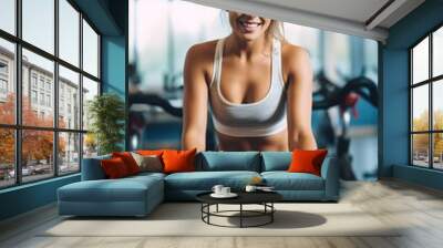 Young beautiful woman with fit body doing fitness in the gym Wall mural