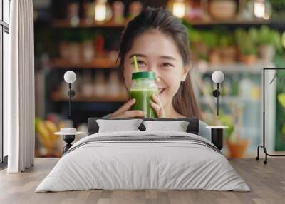 Young Asian Woman Happy Drinking Fresh Green Detox Vegetable Juice. Healthy detox vegan diet with vegetable cold pressed extractor to extract Wall mural