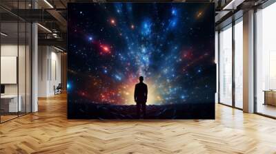 Silhouette of a person standing in awe of a breathtaking cosmic galaxy light projection Wall mural