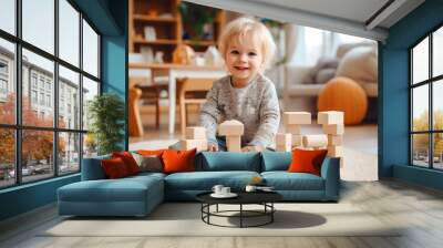 A lifestyle photograph of a young toddler playing with wooden block toys Wall mural