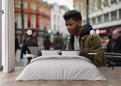 Black man using a laptop in the middle of London. Student or freelancer lifestyle. High quality generative ai Wall mural