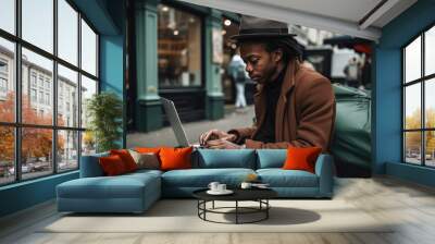 Black man using a laptop in the middle of London. Student or freelancer lifestyle. High quality generative ai Wall mural