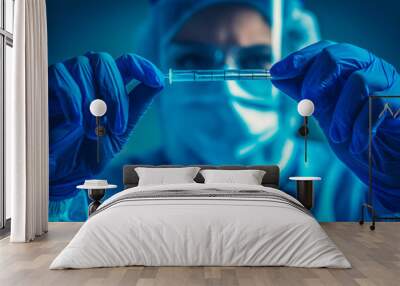 Doctor holding swab test tube for 2019-nCoV analyzing. Coronavirus test. Blue medical gloves and protective face mask for protection against covid-19 virus. Coronavirus and pandemic Wall mural