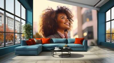 Happy wealthy rich successful black businesswoman standing in big city with modern skyscrapers and sunset, thinking of successful vision, dreaming of new investment opportunities Wall mural