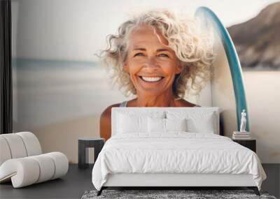 Middle-aged woman holding a surfboard on a beach, radiating vitality, optimism, health, and well-being, aging gracefully and embracing active lifestyle Wall mural