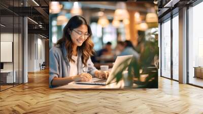 Portrait of a Asian woman working on a laptop computer in a busy cafe in the city Wall mural