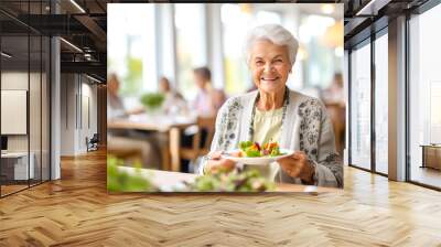 Portrait of a senior woman in a retirement home happily enjoying a healthy lunch. Presentation of a healthy lifestyle of well-being and contentment even at an age Wall mural