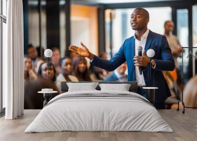 Portrait of engaging African American man wearing a suit, delivers a dynamic corporate presentation. Captivating his audience, he shares insights within a professional boardroom setting Wall mural