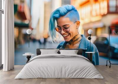 Portrait of millennial girl with blue hair and tattoos, smiling and using smartphone on sunny street in New York City. Concept of casual, carefree, connectivity, candid Wall mural