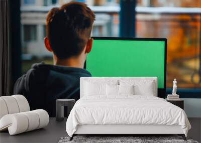 Rearview shot of an unrecognizable young man using his laptop with green screen Wall mural