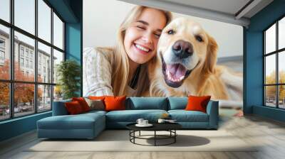 Saving memories with pet. Smiling woman with blond hair snuggling to furry friend and taking selfie on modern cell phone. Obedient golden retriever lying on floor near delighted female owner Wall mural