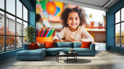 Young girl in school, expressing creativity through art by drawing with colored pencils Wall mural