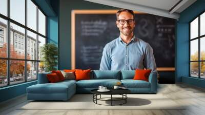 Young male teacher standing in front of blackboard in classroom, generative ai Wall mural