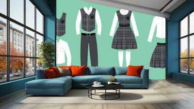 Set school uniforms for a boy and a girl in a cartoon style. Vector illustration of vest,shirt and pants with belt, and blouse with sundress and stockings,blouse with skirt on green background. Wall mural