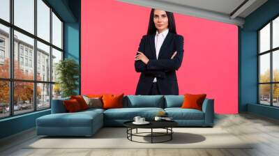 A true professional. Incredibly attractive office worker in a black suit is looking in the camera and posing with folded arms. Wall mural