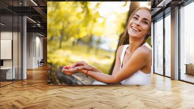 Close up portrait of an adorable and gorgeous brunette woman with profashion make up and hairstyle posing outdoors in sunset with rays of sun. Fashion, style, trendy, model Wall mural