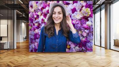 Portrait of attractive woman on flower background Wall mural