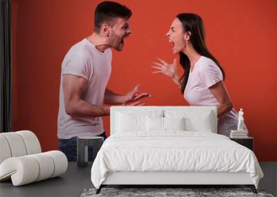 Side view photo of young angry and shouting couple in white t-shirts Wall mural