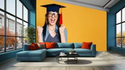 Study, education, university, college, graduate concept on banner. Happy and excited portrait of young student girl in hat of graduation isolated  Wall mural