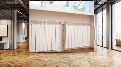 Two new white heat radiators hang on the wall under the window Wall mural