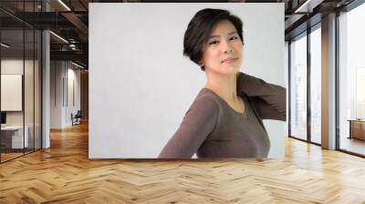 Studio Portrait, Beautiful and stylish matured Asian woman in her 40s feeling cheerful, joyful, content and confident. Casual and happy looking, wrinkles, aging, Middle aged beauty and healthy concept Wall mural