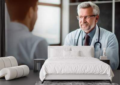 Mature doctor having serious consultation with young male patient in office, explaining treatment and providing recommendations Wall mural