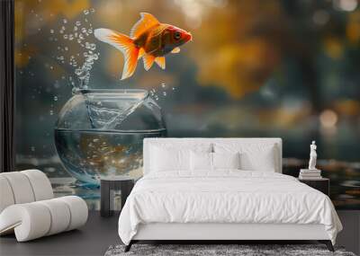 a goldfish jumping out of a glass bowl into a larger lake Wall mural