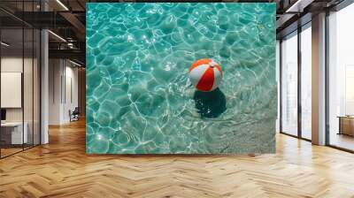 top view of a beautiful white and red ball on the blue water of the sea near the shore on a beach where there is no one, associations with recreation on the water and various activities Wall mural