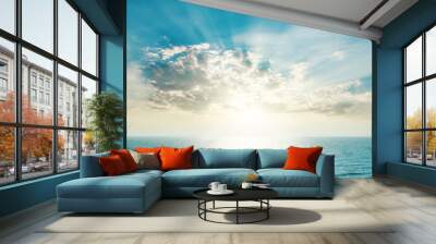 rising sun on the horizon, blue sea and clouds Wall mural