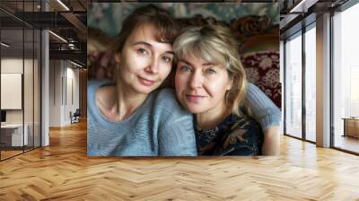 Mom And Adult Daughter Bonding on Couch. Headshot Portrait of Mature Caucasian Mother and Adult Daughter Posing for the Camera Wall mural