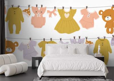 Baby child clothes drying hanging on rope, clean infant garment and accessories after laundry Wall mural