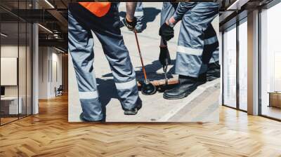 Two workers of emergency gas service, checking concentration of gas in the sewer Wall mural