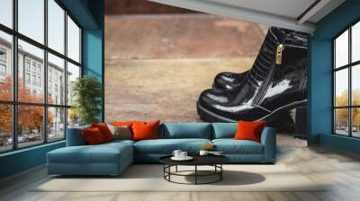 Women's black patent leather boots. Street photo. Fashion advertising shoes photos. Wall mural