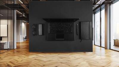 Minimal flat lay on modern businessman black desk with laptop Wall mural