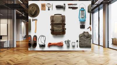 Packing backpack for a trip concept with traveler items isolated on white background Wall mural