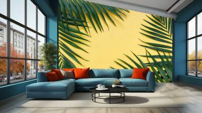 Tropical palm leaves border frame isolated on pastel yellow background isolated Wall mural