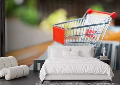 Empty Shopping cart on table with laptop keyboard and copy space for online shopping concept Wall mural