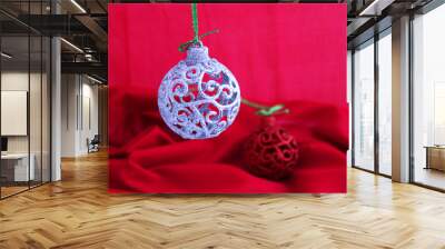 Openwork and shiny Christmas spheres on a red background Wall mural