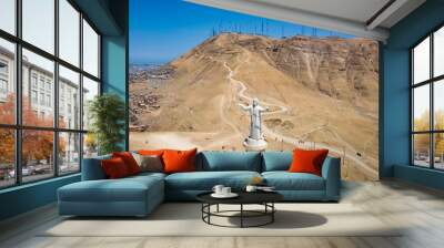 Aerial view of Cristo del Pacifico and Morro Solar hill in the background. Summer day, tourists visiting the monument that was a gift from Alan Garcia and Odebrecht. Wall mural