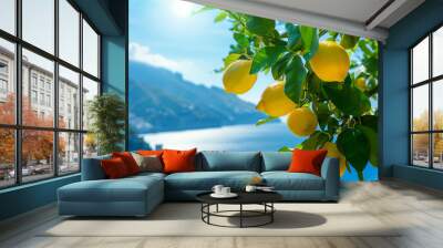 Bright ripe lemons on the tree on the background of the Mediterranean city, sea coast surrounded by green mountains. Wall mural