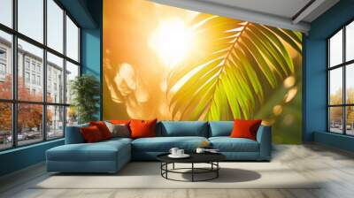 Close-up image of tropical palm leaves in the light of the setting sun Wall mural