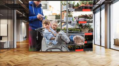 Flower, garden - Father with children shopping plants and flowers in garden center Wall mural