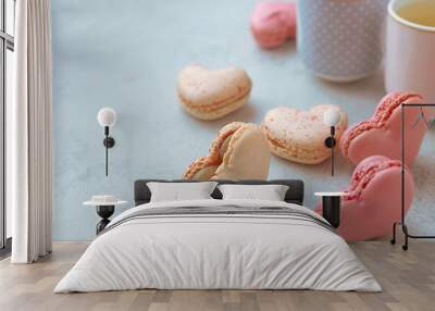 Macarons or French macaroons in heart shapes and two cups on gray background with copy space Wall mural