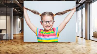 funny cute little girl playing with her hair Wall mural