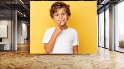 Young kid wearing a white tshirt mockup against a yellow background. T-shirt design template, print, mock-up Wall mural