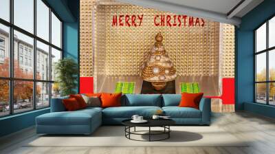 MERRY CHRISTMAS wish on a card or announcement shows gold glitter with a gold decorated Xmas tree. The design is modern minimal geometric shapes with lines & holiday colors in green & red. Wall mural