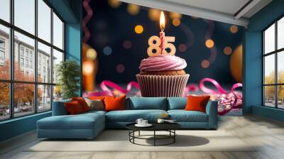 Birthday cupcake with burning lit candle with number 85. Number eighty-five for eighty-five years or eighty-fifth anniversary. Wall mural